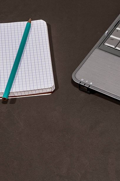 Closeup image of notebook with text BREAKOUT SESSION on office desk.
