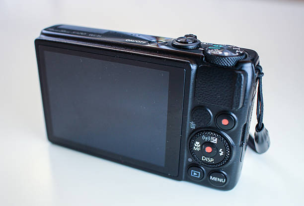 istock Back view of a black Canon Powershot camera displays its settings, buttons, and LCD screen. 2217345402