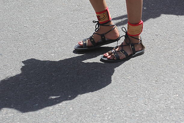 istock Unknown person's feet wearing traditional sandals 2217346688