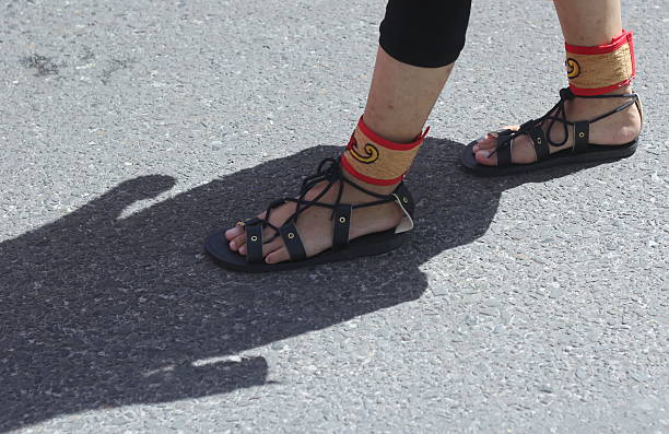 A person's feet wearing traditional sandals