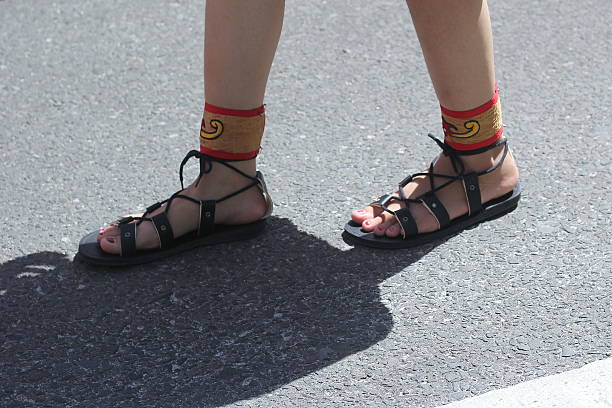istock Unknown person's feet wearing traditional sandals 2217346707