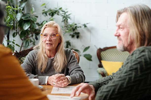 istock Engaging Seniors Discussing Plans in Cozy Living Room 2217348242