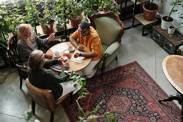 istock Discussing Over Coffee at Cozy Cafe Surrounded by Greenery 2217348268