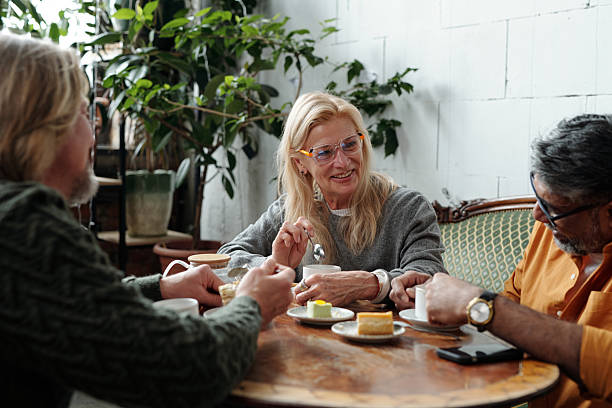 istock Elderly Individuals Engaging in Conversation Over Lunch 2217348316