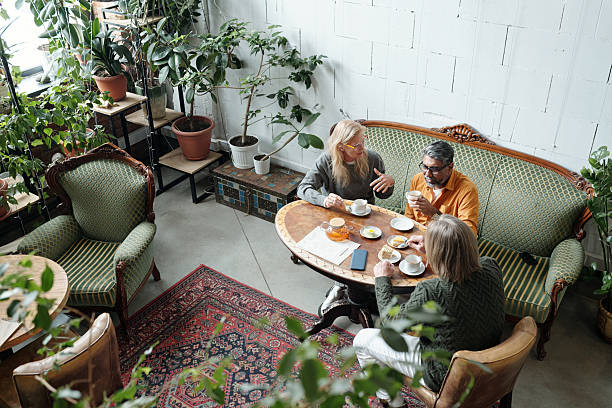 istock Enjoying Coffee in Cozy Plant-Filled Cafe 2217348336