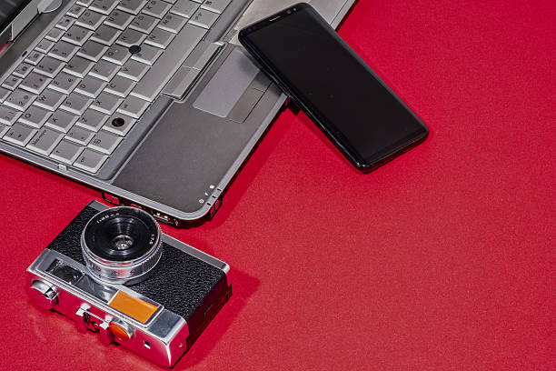 istock Camera, Laptop, And Smartphone On Red 2217348463