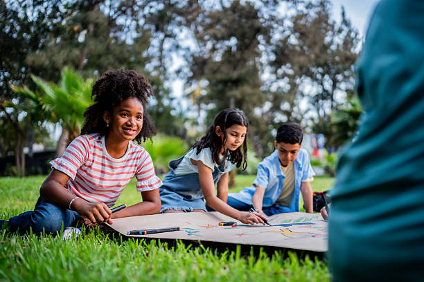 istock Kids talking and painting on public park 2217349575