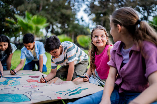 istock Kids talking and painting on public park 2217349576