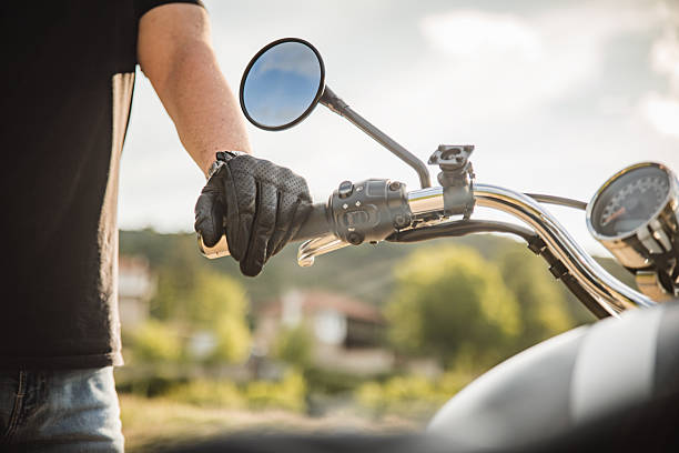 Close up of a biker next to his motorcycle