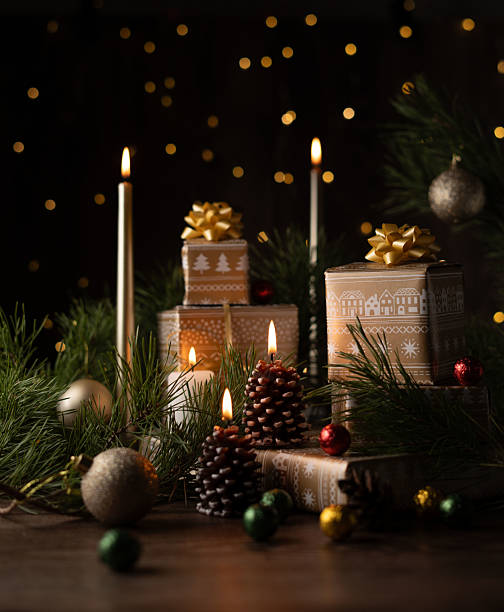 istock Aesthetic Holiday Arrangement Featuring Wrapped Gift Boxes, Glowing Candles, Pinecones, and Sparkling Decorations for Festive and Cozy Seasonal Atmosphere 2217351571