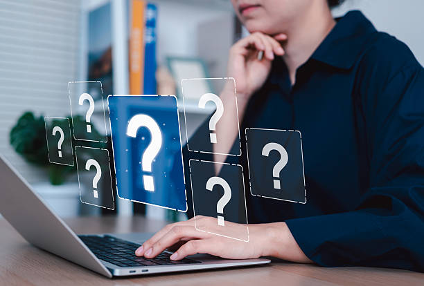 Online Question and Customer Support Inquiry Concept. Woman using laptop with question mark icons, symbolizing online help, customer support, technical inquiries, digital problem-solving assistance,