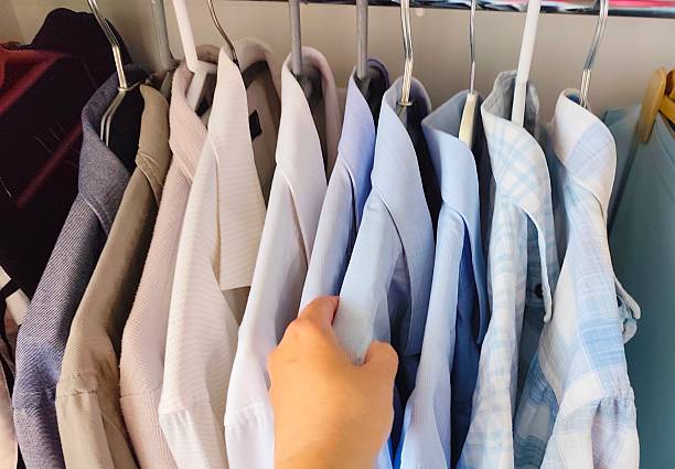 istock Men's shirts hanging in the closet 2217358687