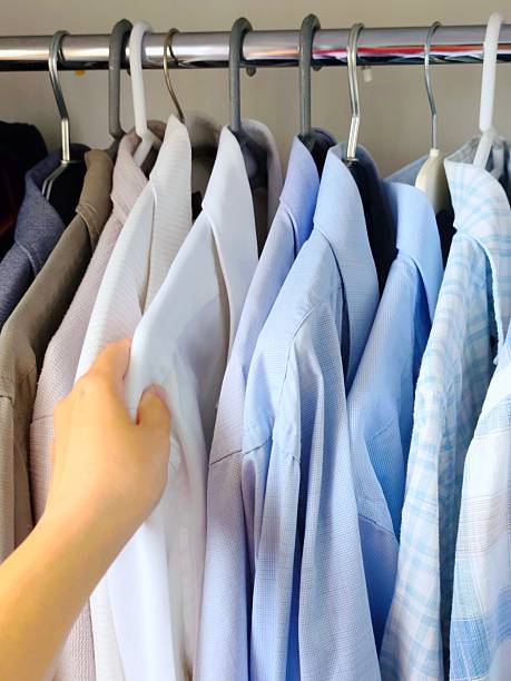 istock Men's shirts hanging in the closet 2217359068