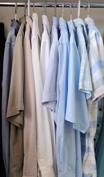 istock Men's shirts hanging in the closet 2217359315