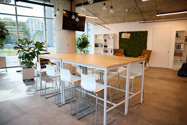 istock Modern coworking space with tables, chairs and plants 2217360034