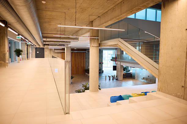 istock Modern open space office interior with concrete and wood finishes 2217360045