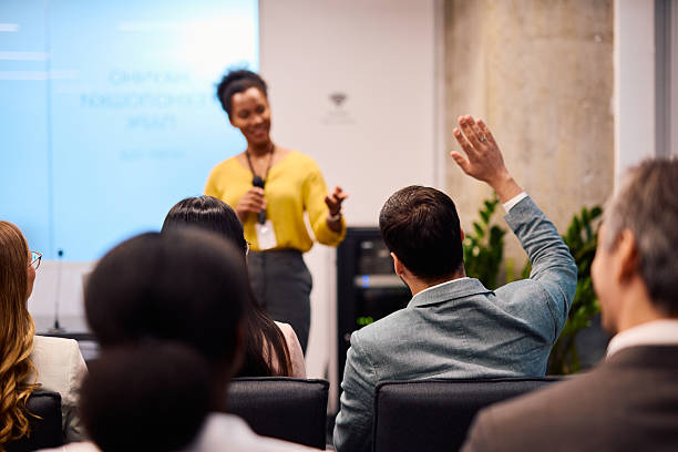 istock Businessman raising hand during a presentation in a conference room 2217360051