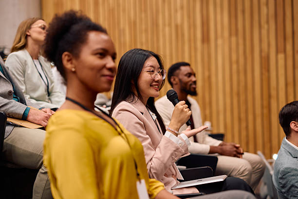 istock Young businesswoman asking a question during a conference 2217360147