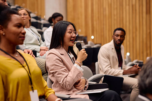 istock Young businesswoman asking a question during a conference meeting 2217360148