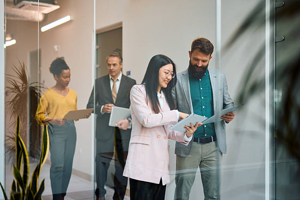 istock Business people walking and discussing work in office hallway 2217360166