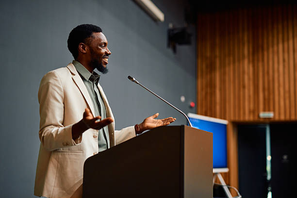 istock Motivational speaker inspiring audience with his speech during a conference 2217360182