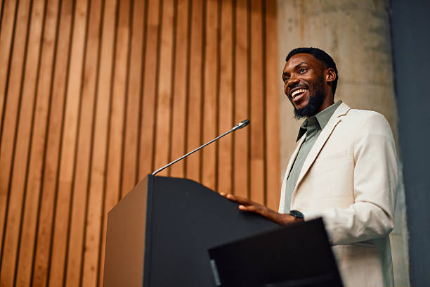 istock Motivational speaker inspiring audience with his speech at corporate seminar 2217360184