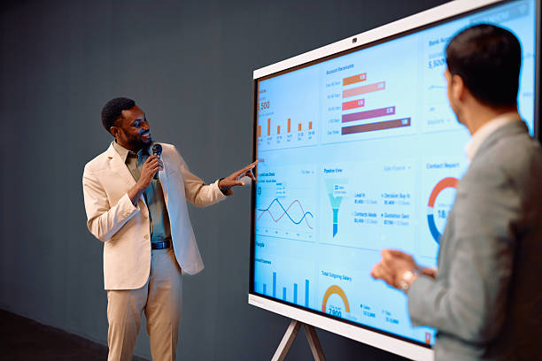istock Businessman explaining diagrams and charts on digital whiteboard during a presentation 2217360293