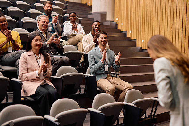 istock Audience clapping hands after a successful presentation in a conference room 2217360448