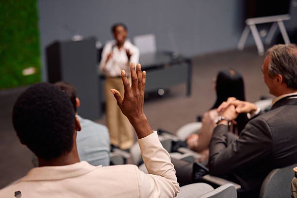 istock Businessman raising hand asking question during a conference meeting 2217360506