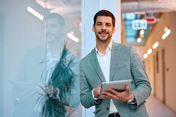 istock Young businessman using digital tablet in modern office 2217360817