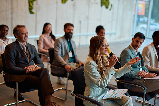 istock Businesswoman speaking at a conference using a microphone 2217360984