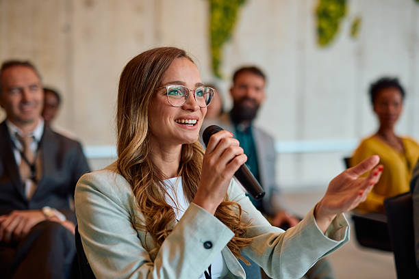 istock Young businesswoman speaking at a conference using a microphone 2217360995