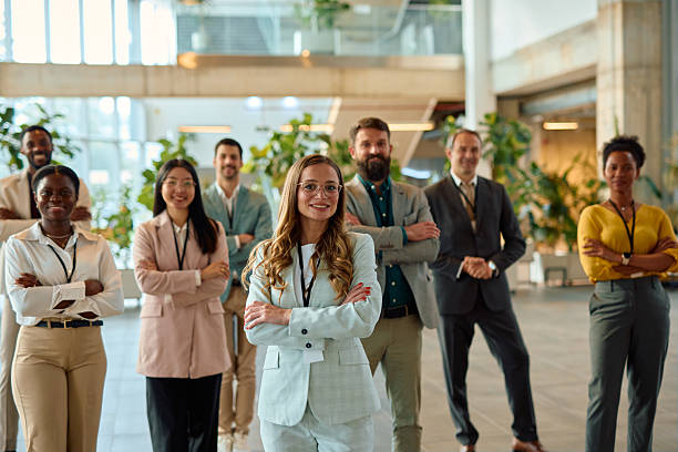 istock Diverse business team posing with crossed arms in modern office lobby 2217361229