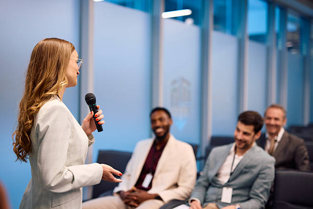 istock Young businesswoman speaking at a conference using microphone 2217361279