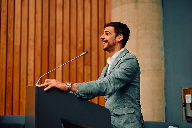 istock Motivational speaker inspiring audience with his speech during a conference 2217361280