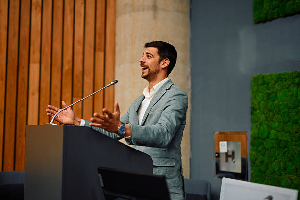 istock Motivational speaker inspiring audience with his speech at corporate seminar 2217361303