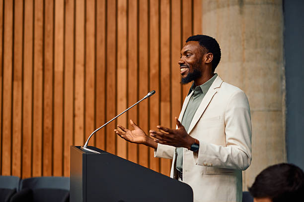 istock Motivational speaker inspiring audience with his speech during a conference 2217361379