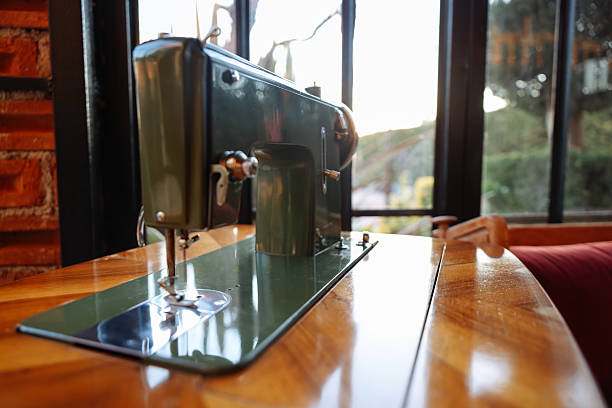 Vintage hand sewing machine. Black sewing machine on a wooden stand.