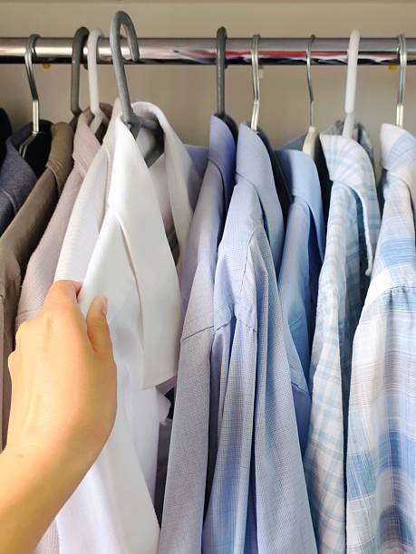 istock Men's shirts hanging in the closet 2217364152