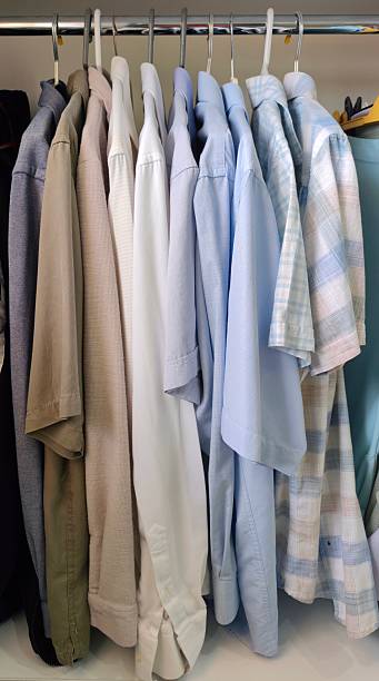 istock Men's shirts hanging in the closet 2217364239