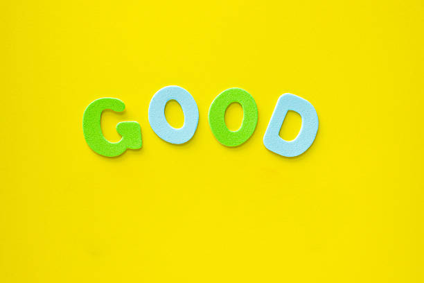 The Word Good made from multicolored letters on Yellow Background with copy space. Learning alphabet for kids.