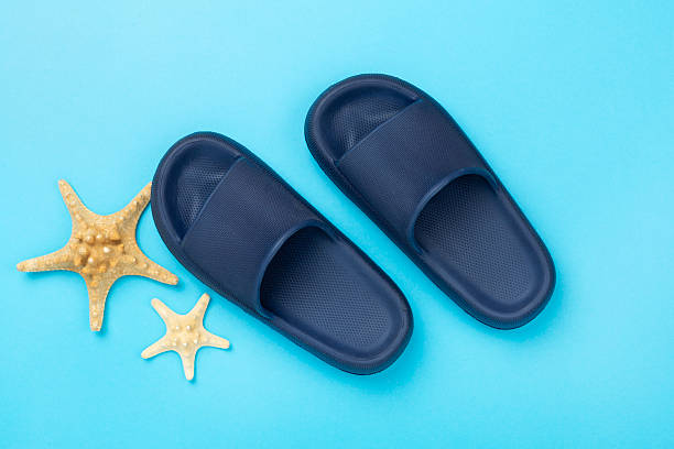 istock Blue sandals on color background,top view 2217370301