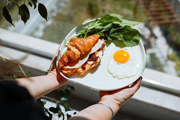 Home made freshness bacon,fried egg with avocado ,tomato and rocket leaves on fried soda bread