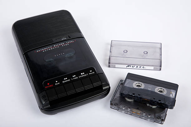 Analog audio cassette player with audio tapes, on white background.