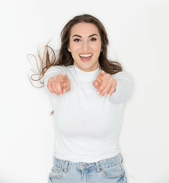 istock Woman portrait on white background pointing at the camera 2217373502