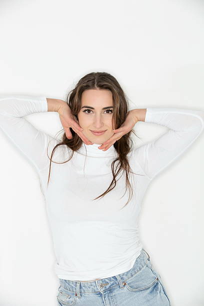 Woman portrait on white background creating a frame around her face with both hands