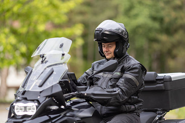 istock A man is sitting on his motorcycle on road and using a mobile phone 2217375807