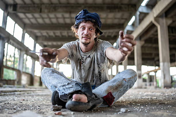 istock Distressed Man Sitting in Abandoned Building with a Desperate Expression 2217376952
