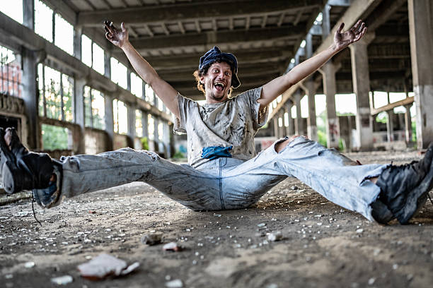istock Joyful Man Sitting Casually in an Abandoned Industrial Building 2217377027