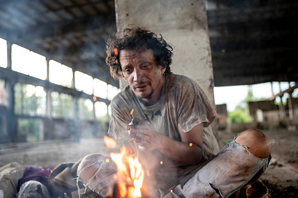 istock Person Sitting By a Fire in an Abandoned Building 2217377074